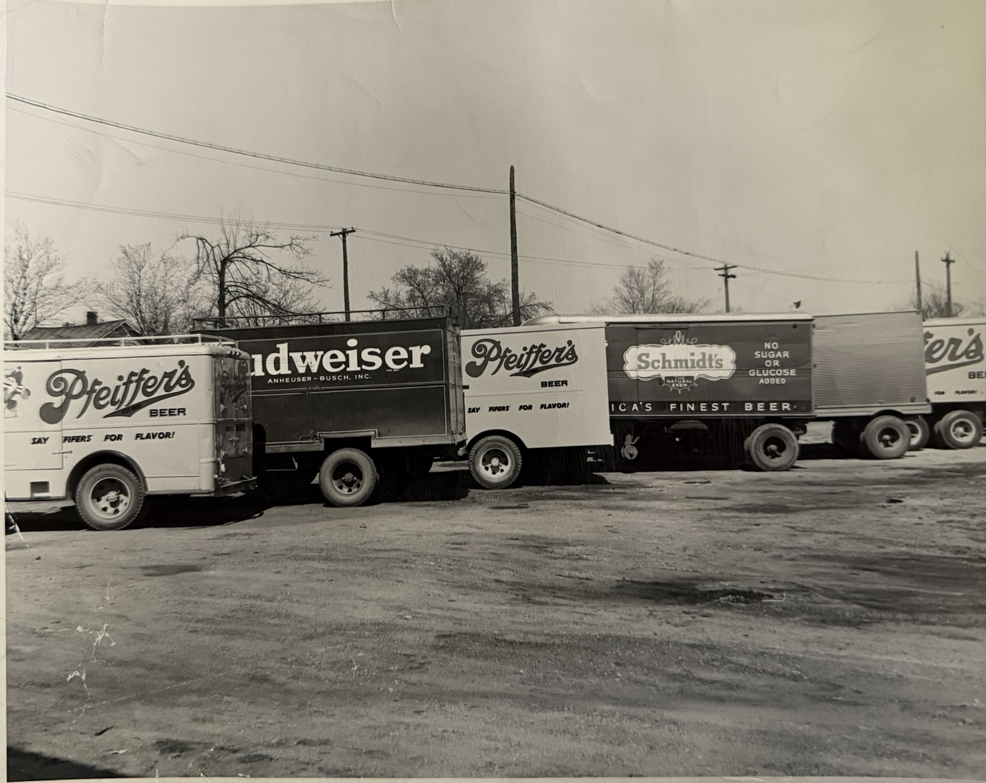 Vintage delivery trucks with Pfeiffer's, Budweiser, and Schmidt's branding
